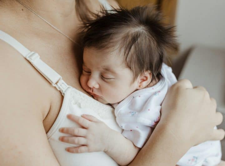 a woman holding a baby in her arms